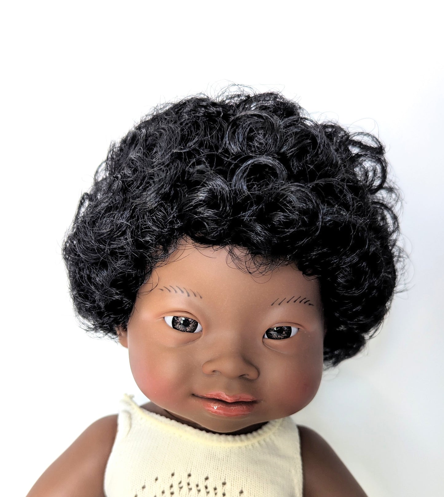 Close up image of Baby Doll with Down Syndrome African Girl face