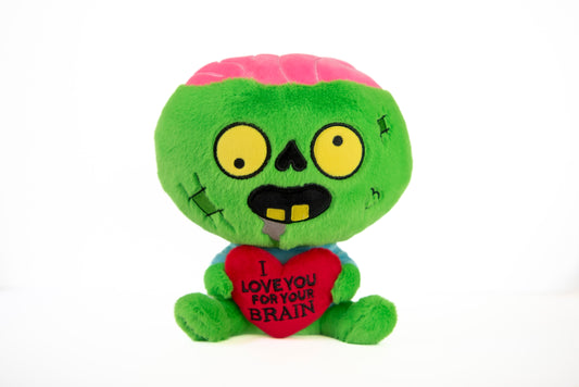A green zombie plush with a pink brain that is holding a heart that reads "I  Love You For Your Brain"