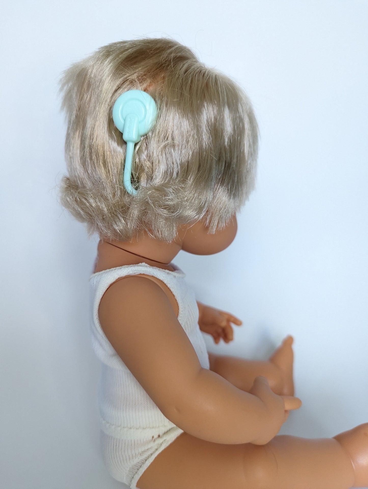 Close up image of Baby Doll Caucasian Girl Hearing Implant 